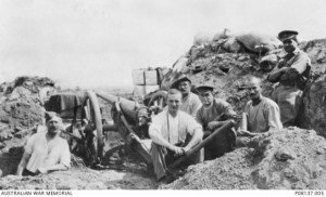 John Newmarch (centre in white shirt), with his 12 pounder gun, Gallipoli. AWM image P08137.005.